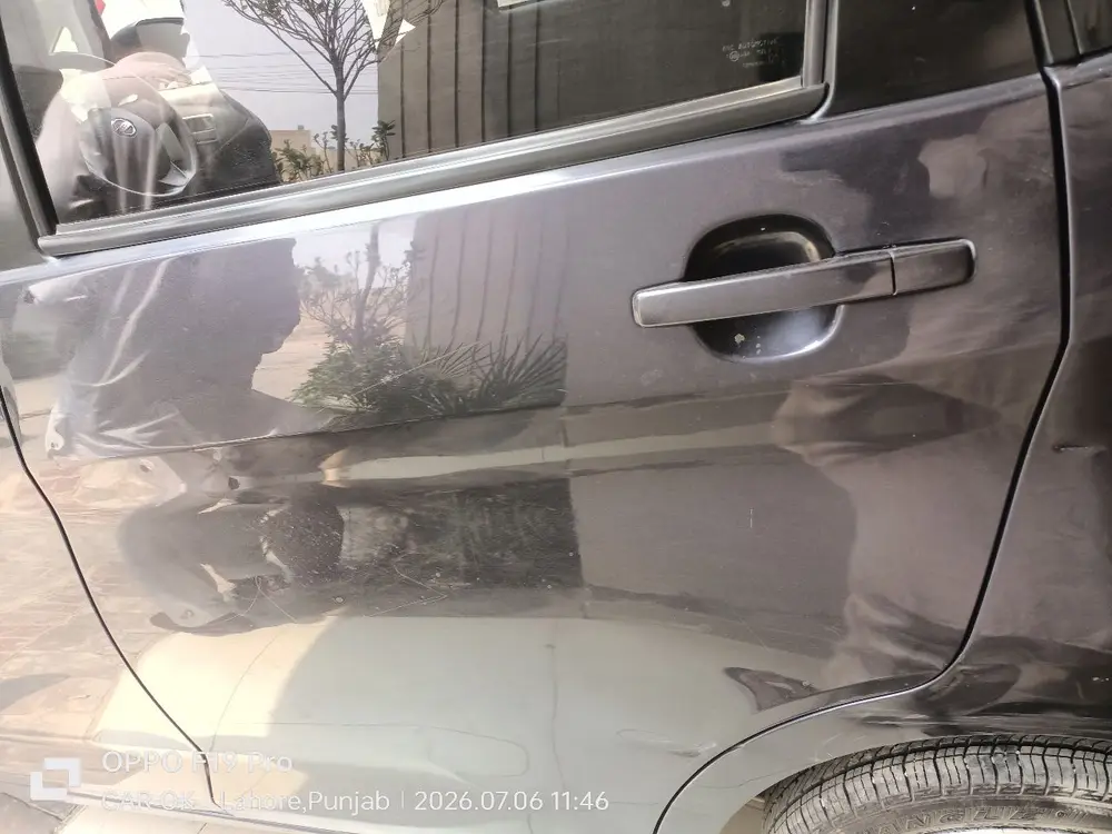Repaired rear-door damage a buyer would never spot in ad photos